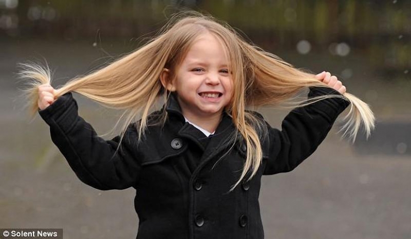 The boy gives her long hair to charity