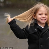 The boy gives her long hair to charity