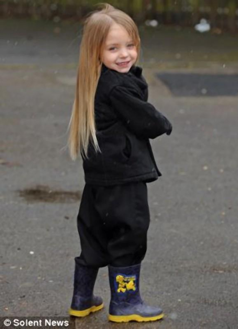 The boy gives her long hair to charity