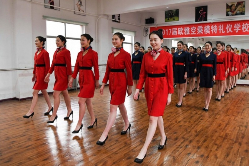 Chinese flight attendants are taught to smile, walk, stand and sit