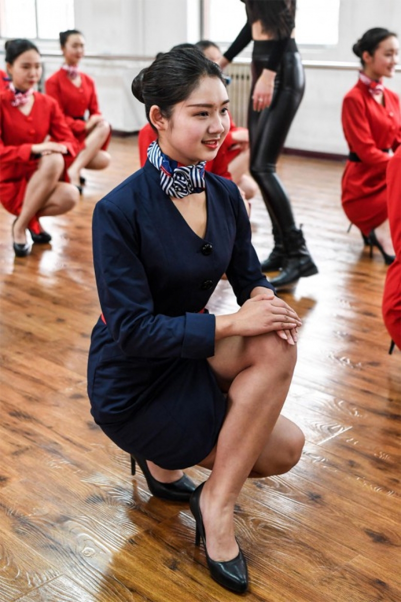 Chinese flight attendants are taught to smile, walk, stand and sit