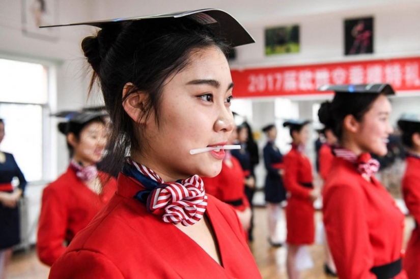 Chinese flight attendants are taught to smile, walk, stand and sit