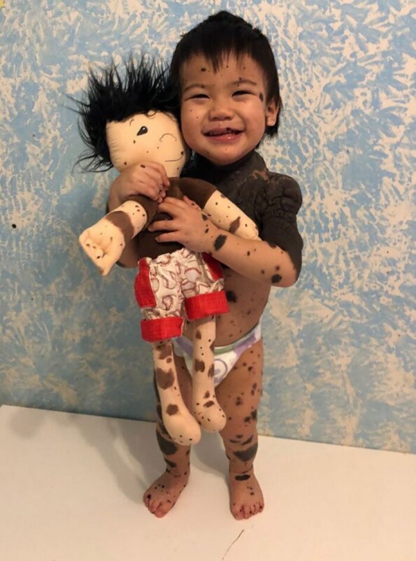 Woman sews a special doll for children with disabilities