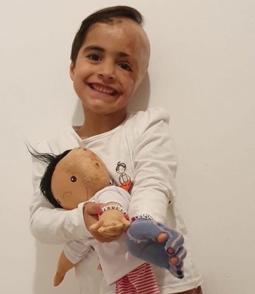 Woman sews a special doll for children with disabilities
