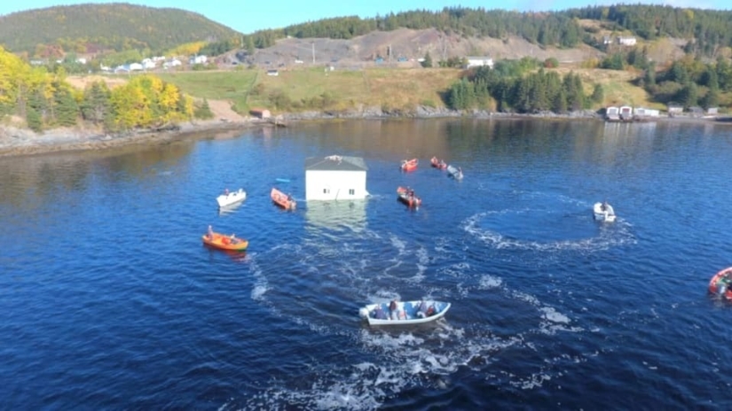 A couple from Canada transported their dream home by swimming across the lake on a homemade raft