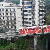 In China, a train passes right through a residential building