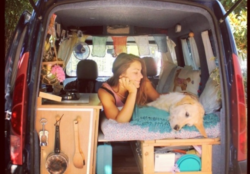 The girl has converted an old van into a motorhome and travels the world with his dog