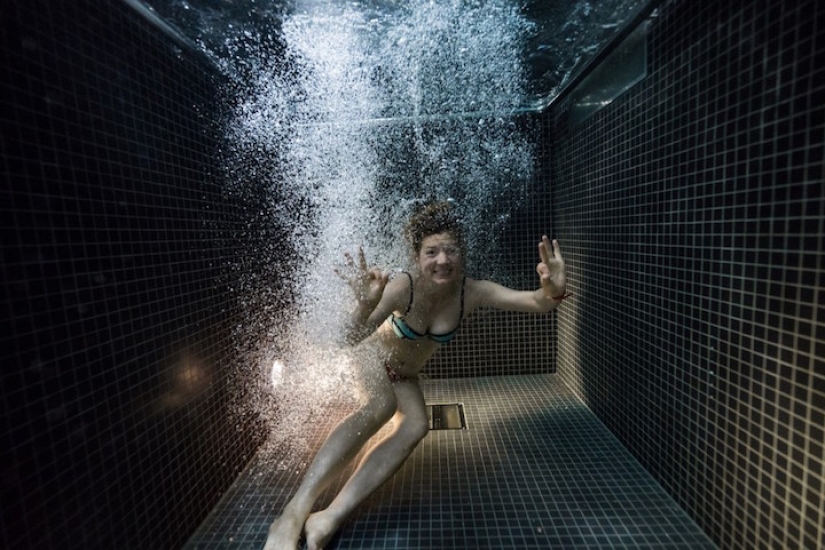 Underwater portraits of people who dived into a pool of icy water