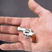 Yes, he's shooting! The smallest combat revolver was made in Switzerland