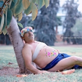 A father of two children with a "beer belly" staged a parody of a typical pregnant photo shoot