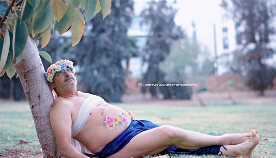 A father of two children with a "beer belly" staged a parody of a typical pregnant photo shoot