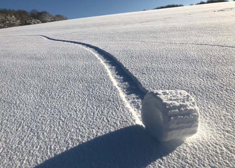 A rare natural phenomenon was observed on the field in the UK — snow rolls