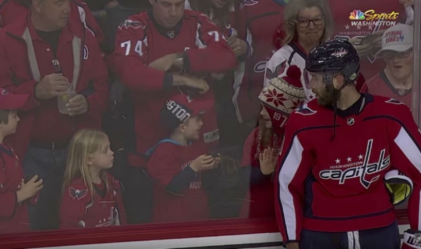 An NHL hockey player stubbornly tried to give a little girl a puck. It turned out the third time