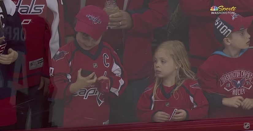 An NHL hockey player stubbornly tried to give a little girl a puck. It turned out the third time