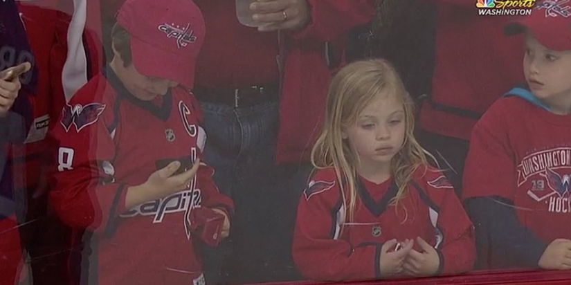 An NHL hockey player stubbornly tried to give a little girl a puck. It turned out the third time