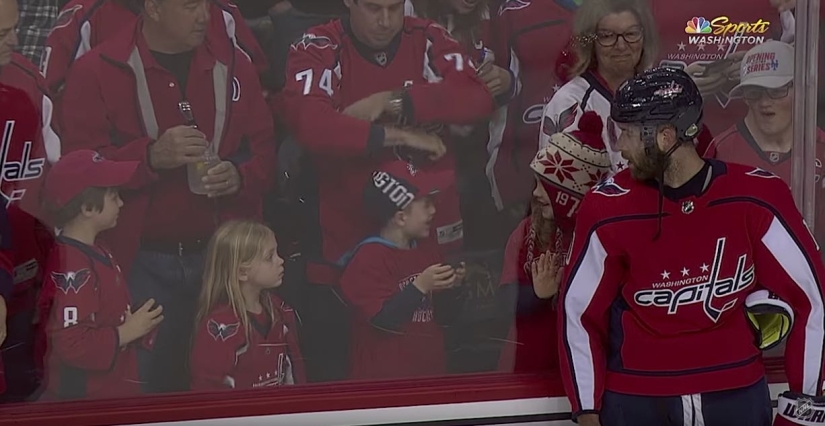 An NHL hockey player stubbornly tried to give a little girl a puck. It turned out the third time