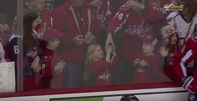 An NHL hockey player stubbornly tried to give a little girl a puck. It turned out the third time