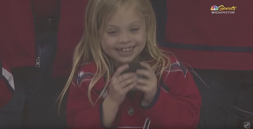 An NHL hockey player stubbornly tried to give a little girl a puck. It turned out the third time