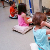 Children read aloud at an animal shelter to help bullied and shy dogs adapt