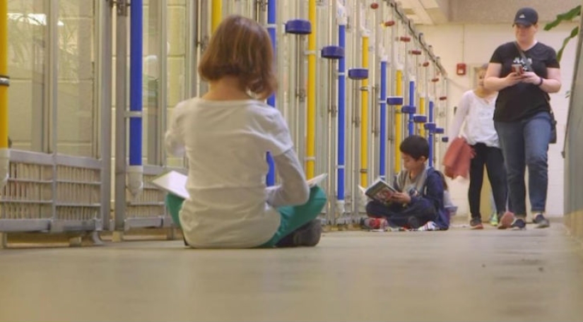 Children read aloud at an animal shelter to help bullied and shy dogs adapt