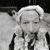 Happy pig farmer and his pets