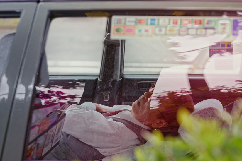 Japanese taxi drivers sleeping in the middle of the street in the middle of the day in William Green's photo series