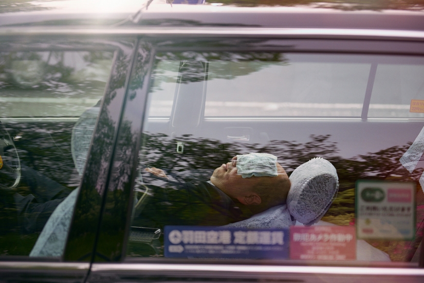 Japanese taxi drivers sleeping in the middle of the street in the middle of the day in William Green's photo series
