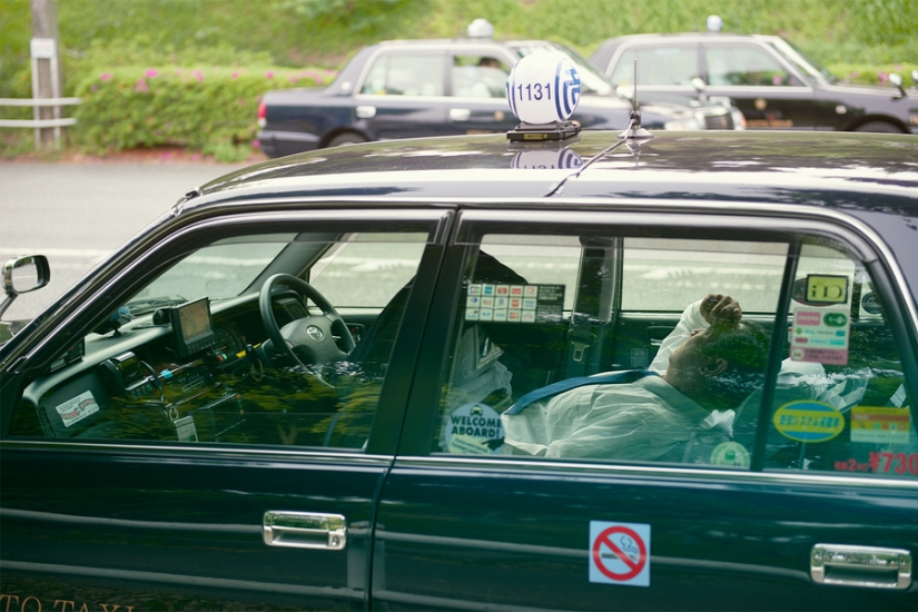 Japanese taxi drivers sleeping in the middle of the street in the middle of the day in William Green's photo series