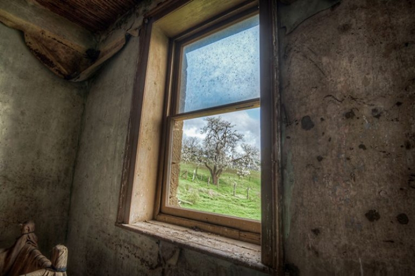 Photographer taking pictures of windows in abandoned places