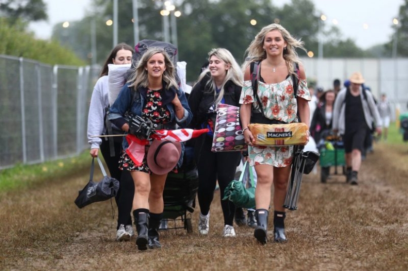 Rubber mood: Glastonbury greets participants in raincoats and with a killer dose of alcohol