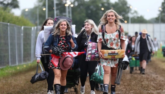 Rubber mood: Glastonbury greets participants in raincoats and with a killer dose of alcohol