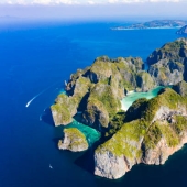 Take me back to the beach! The beautiful Thai bay made famous by Leonardo DiCaprio's famous movie reopens after a three-year coral rejuvenation project