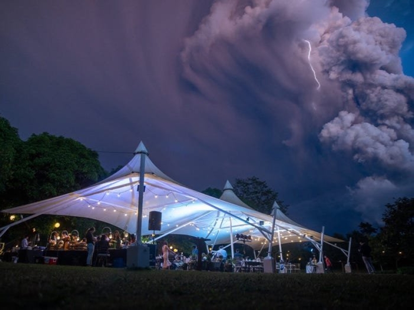 Wedding ceremony against the backdrop of an erupting volcano in the Philippines