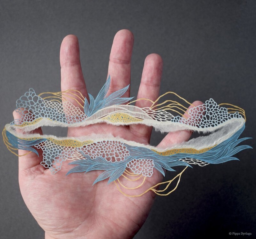 A girl cuts out intricate masterpieces from paper