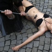 Animal rights activists brand themselves with a red-hot iron