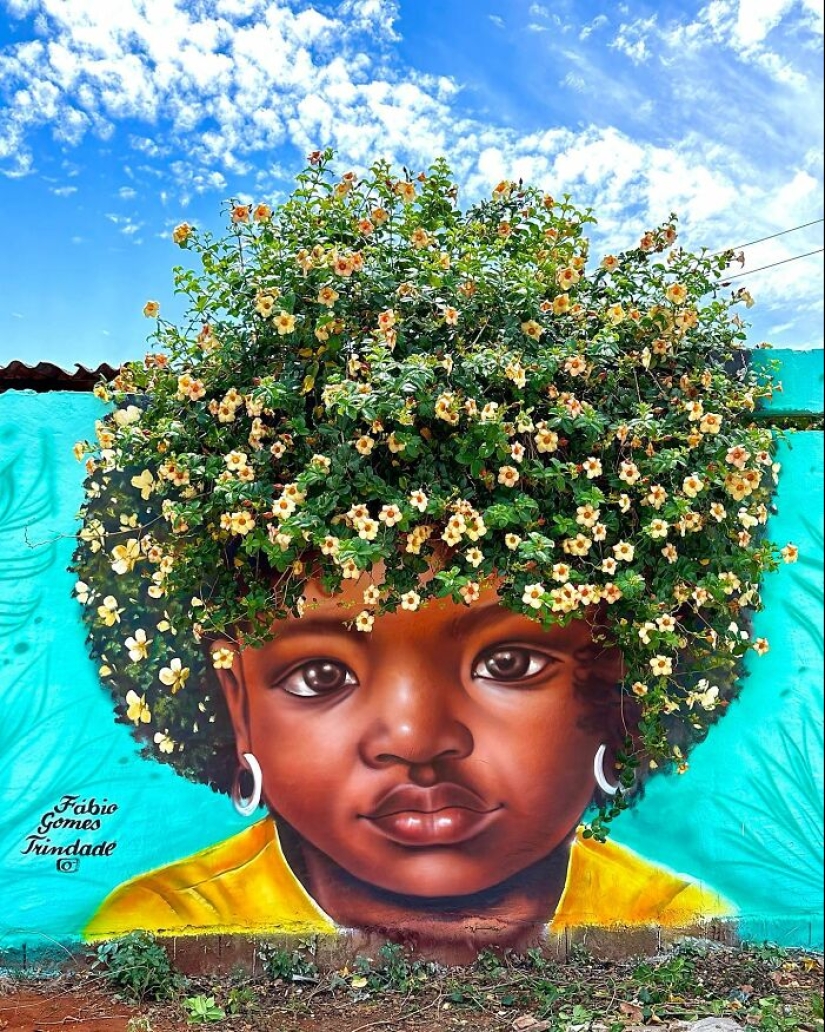 Artista callejero continúa pintando retratos en paredes junto a árboles que también sirven como cabello