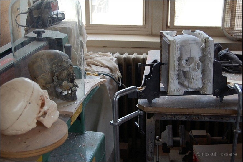 Step-by-step process of carving a skull from old books