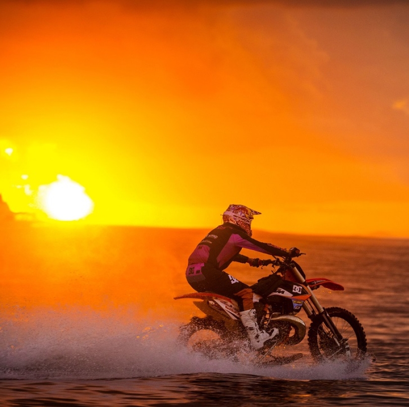 Surfing legend: Robbie Maddison rides a wave on a motorcycle