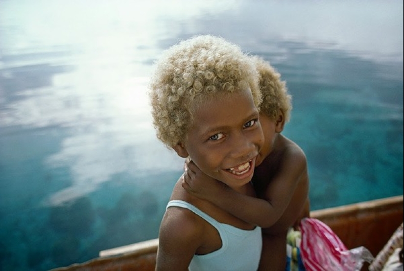 Where did dark-skinned people with light hair come from in Melanesia
