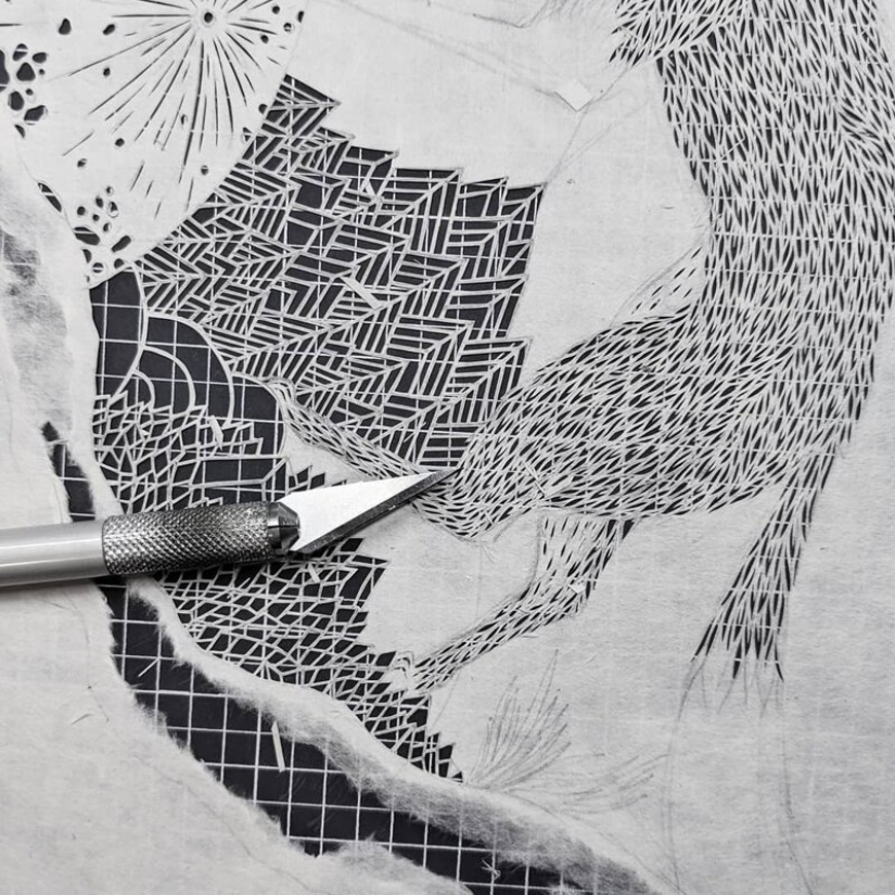 A girl cuts out intricate masterpieces from paper