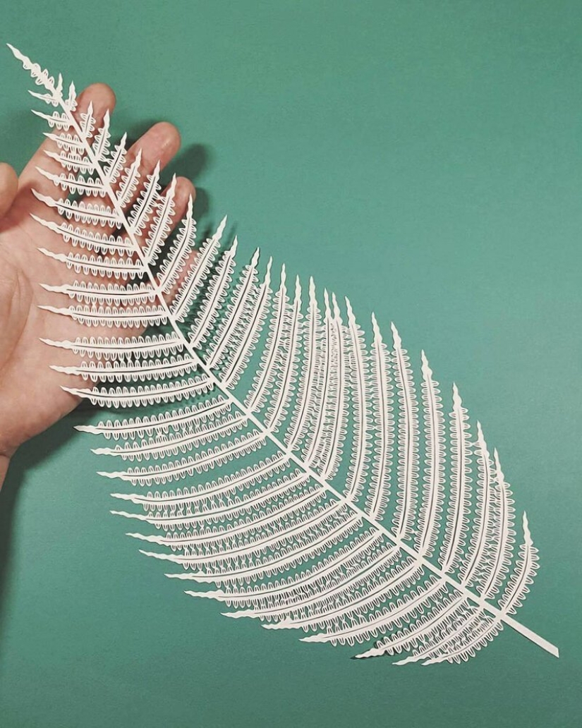 A girl cuts out intricate masterpieces from paper