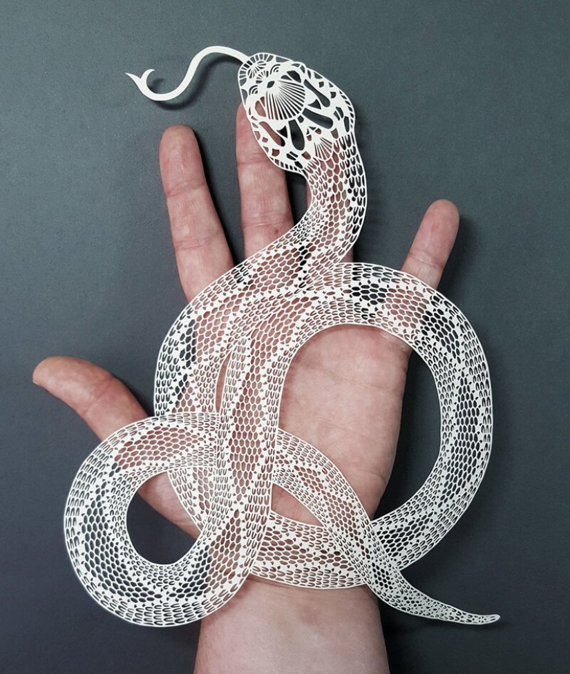 A girl cuts out intricate masterpieces from paper