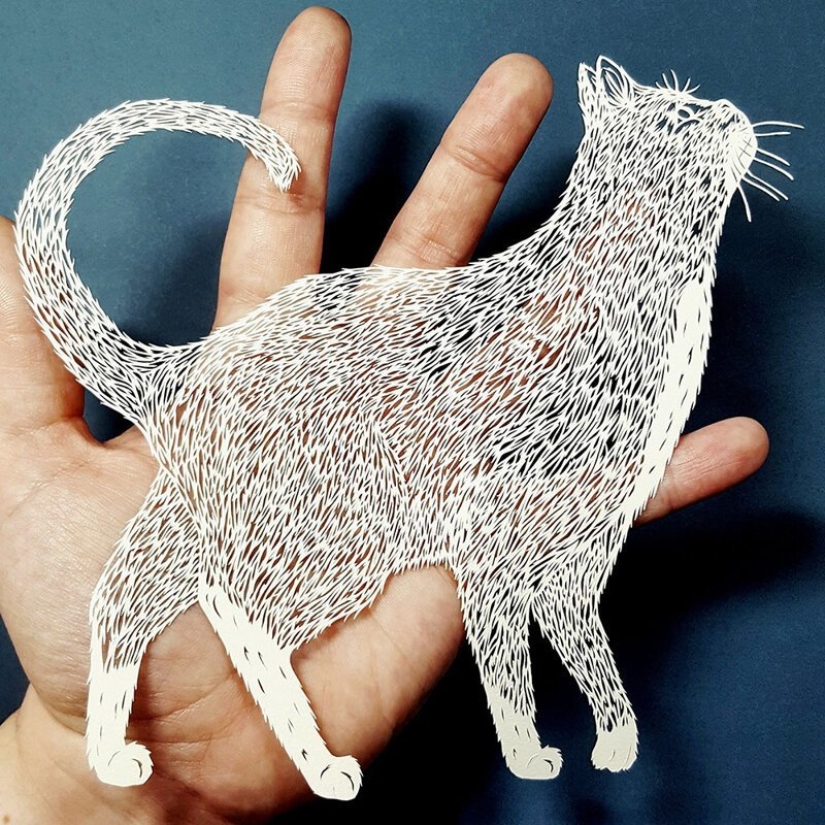 A girl cuts out intricate masterpieces from paper