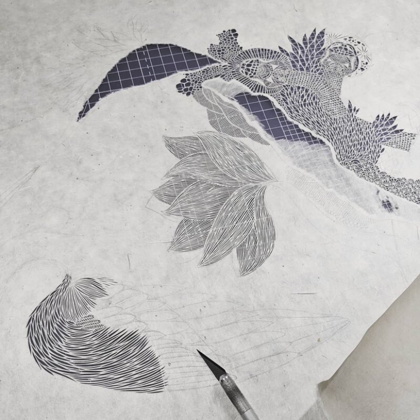 A girl cuts out intricate masterpieces from paper