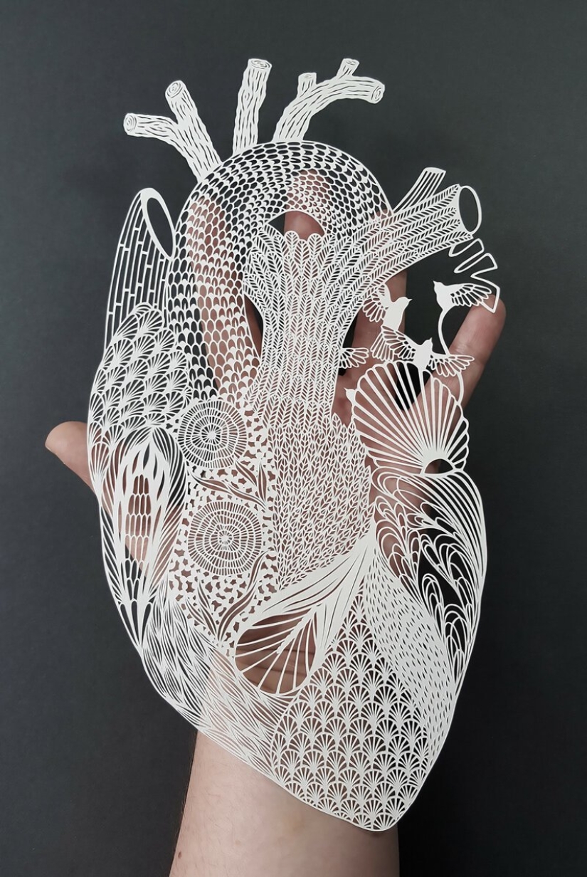 A girl cuts out intricate masterpieces from paper