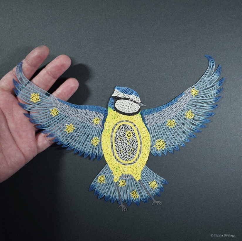 A girl cuts out intricate masterpieces from paper