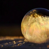 Crystal balls — a girl photographs soap bubbles in the cold