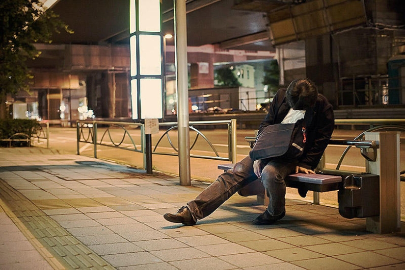 Exhausted Tokyo residents sleeping on the street