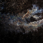 Illusory galaxies and constellations made of gasoline and oil on asphalt