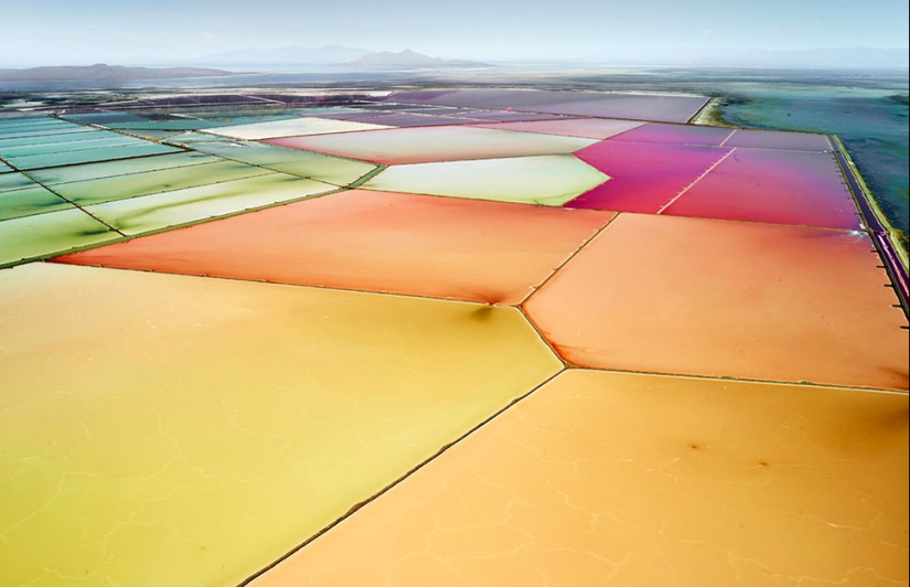 Images of saltworks from a height, blurring the boundaries between photography and painting